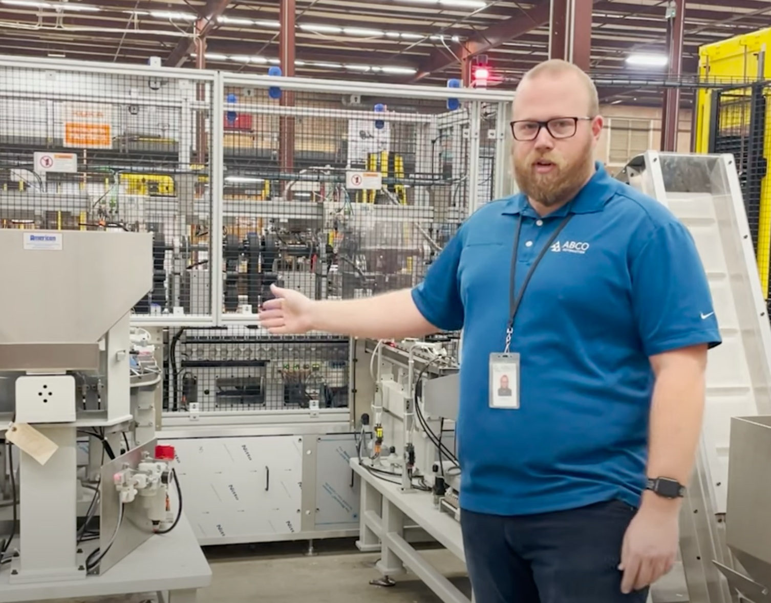 ABCO Engineer gestures toward equipment